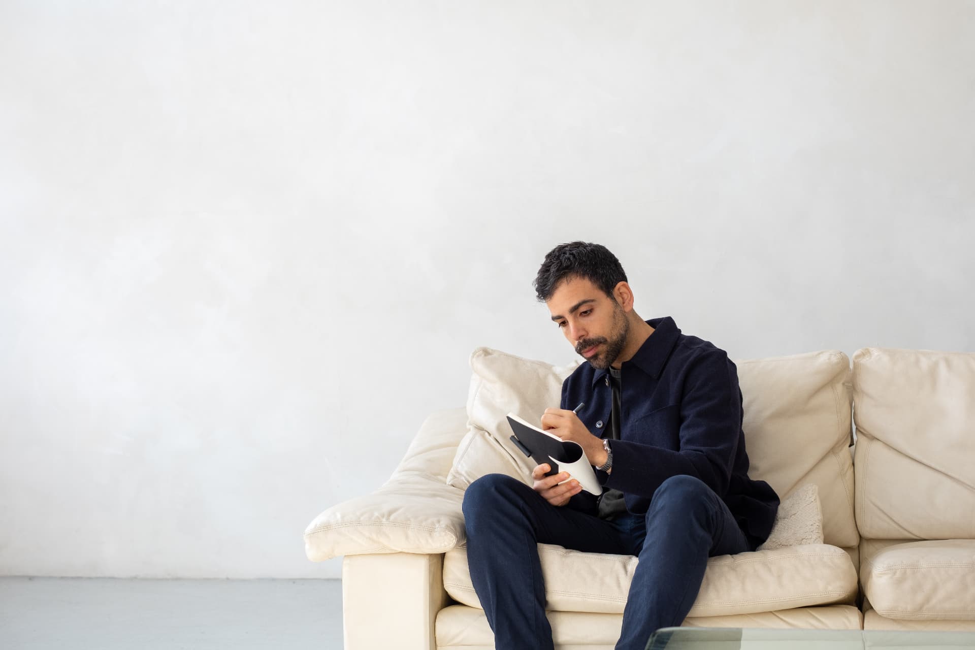 Giuseppe, dating coach for professional men in London, writing in a notebook